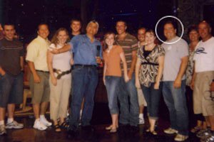Joe Tolley standing in a group photograph with Jay Leno