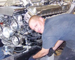 Jessie fabricating the frame beside the V12 engine