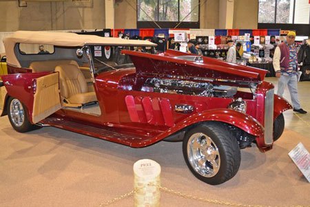 1932 Ford Phaeton displayed at an indoor car show