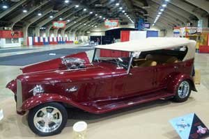 Side view of the burgundy Phaeton at a car show